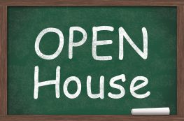 Chalkboard with text of Open House with a piece of chalk
