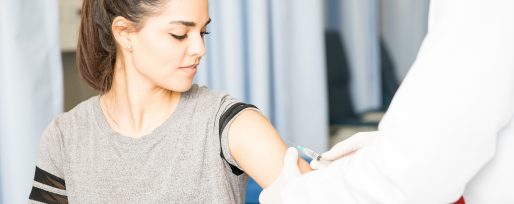 Female Patient Getting Vaccine On Her Arm By