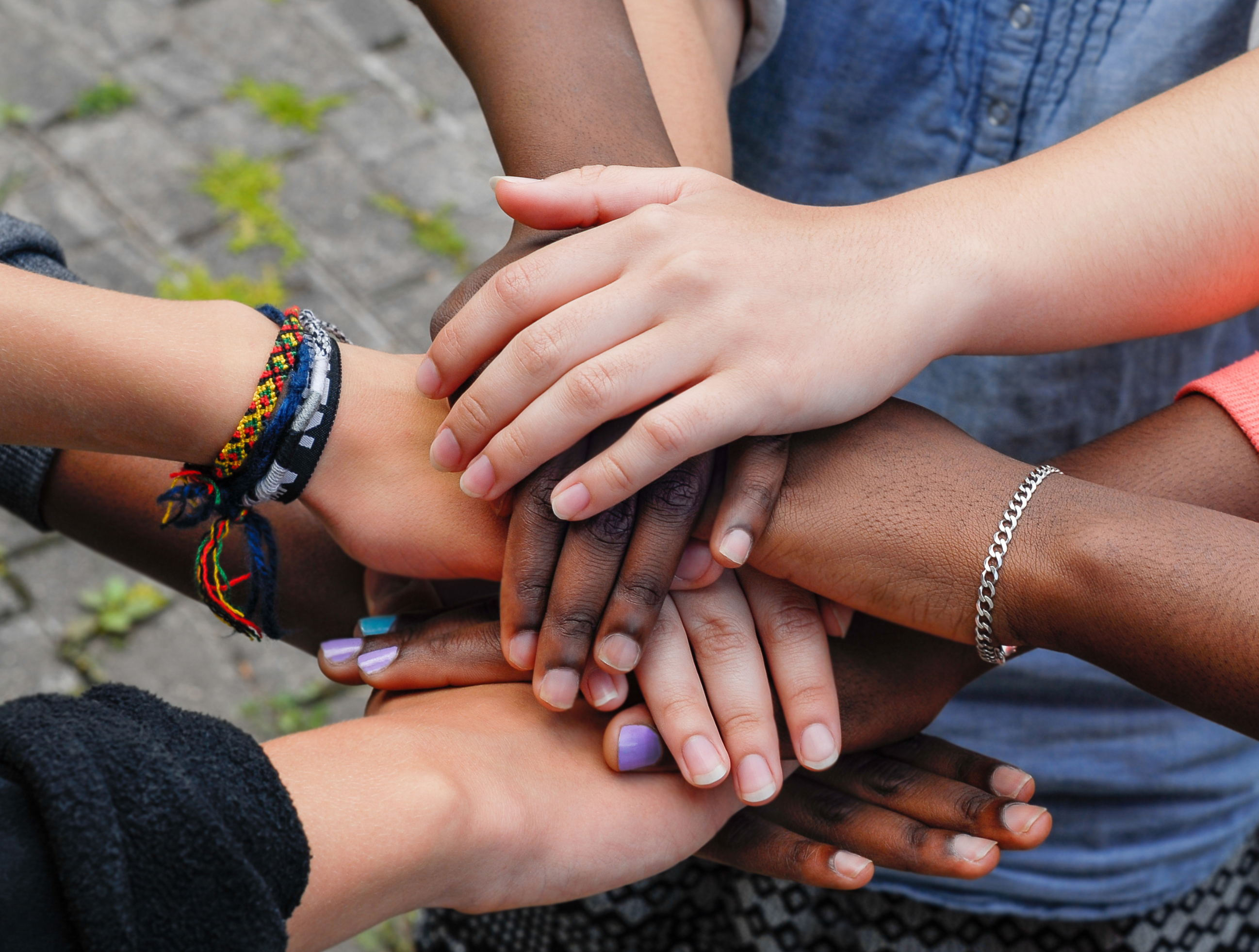 Multiracial children holding hands